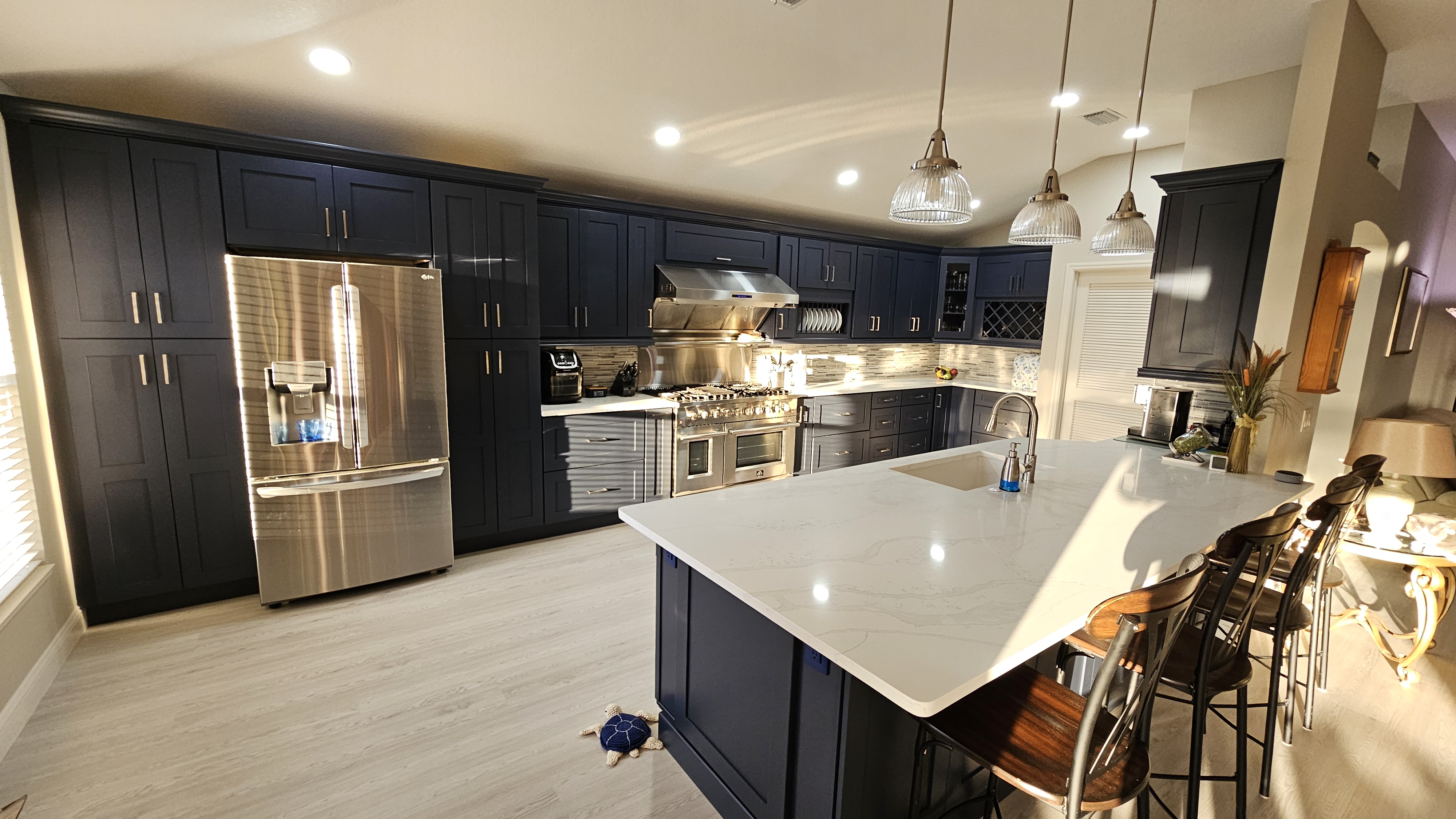 Navy shaker kitchen with a marble waterfall island