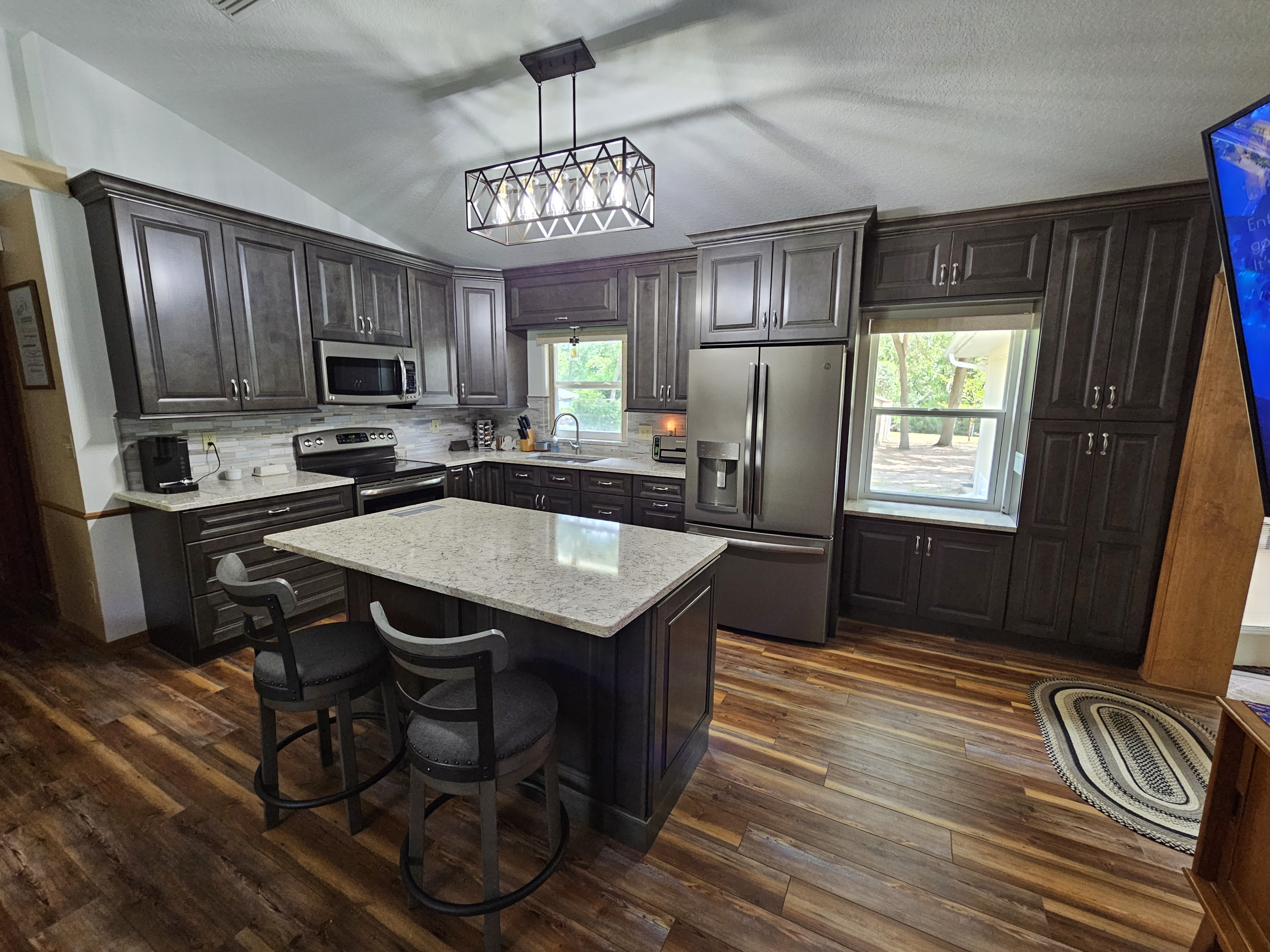 Dark raised panel kitchen cabinets with luxury vinyl plank flooring